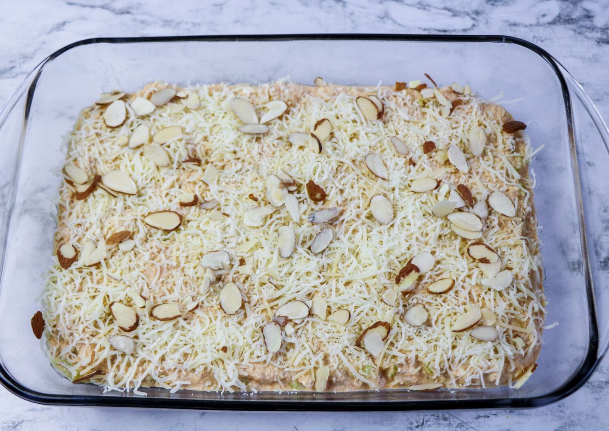 Adding almonds and cheese to casserole dish