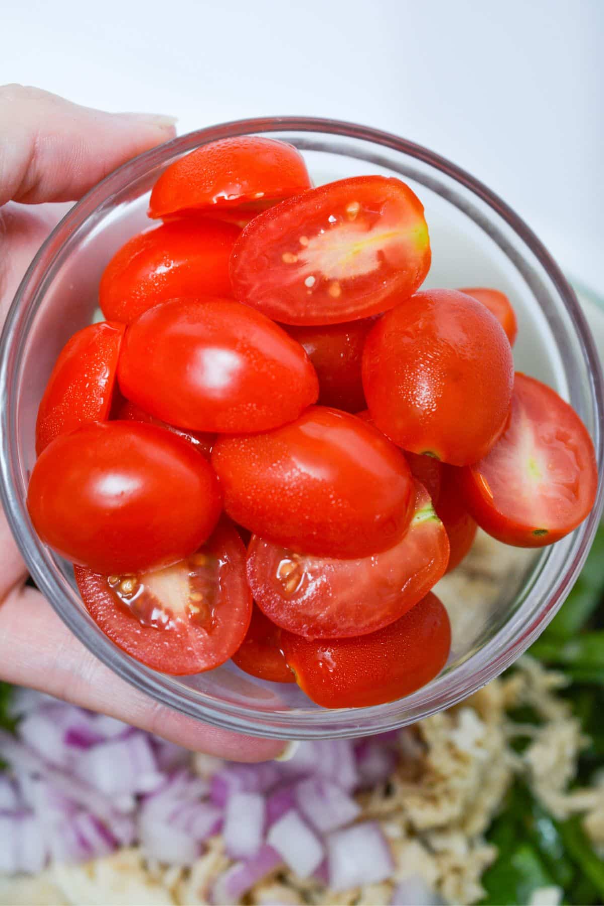 tomatoes going into salad