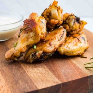 Garlic and herb chicken wings on cutting board